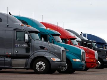 Semi-trucks parked beside each other