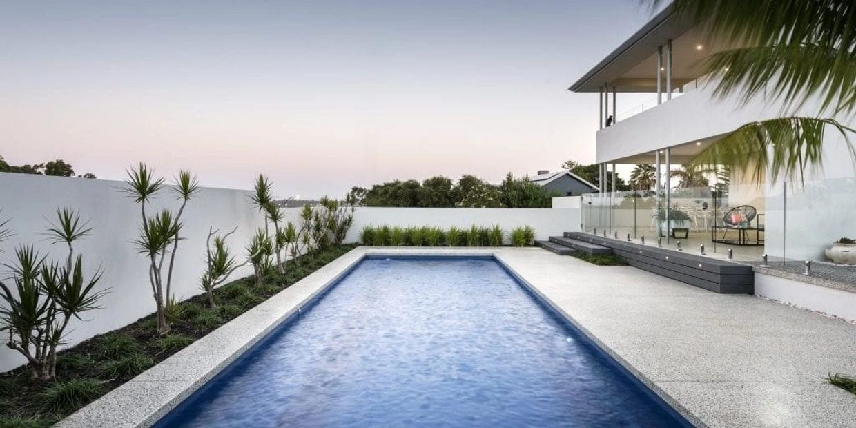 Modern backyard with a rectangular pool and minimalist landscaping.