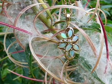 Flower-shaped pendant among plant fibers.