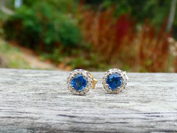 Gold earrings with blue stones and diamonds.