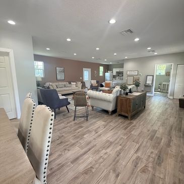 Modern living room with wood flooring and neutral furniture.