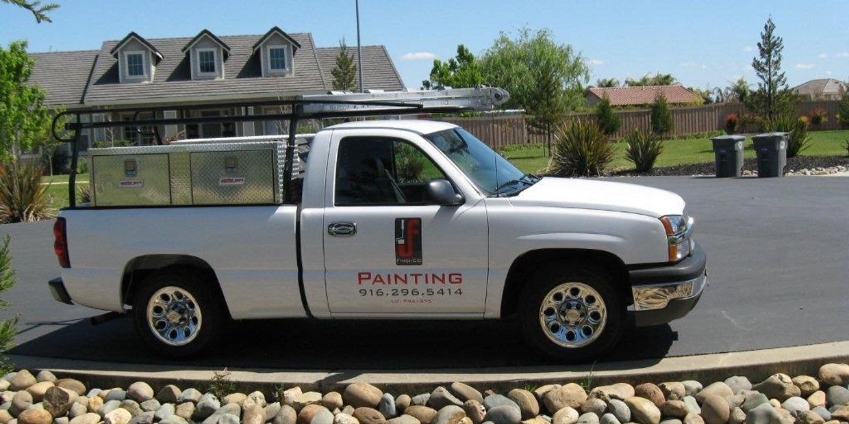 White work truck with FinchCO Painting Inc's logo on the side.