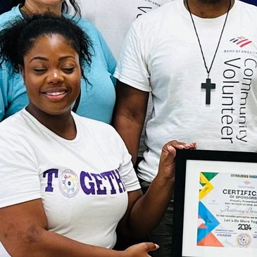 Smiling woman holding a framed certificate, wearing a 'TOGETHER' shirt.