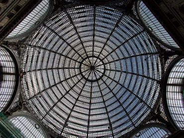Intricate glass dome ceiling with radial metal framework.