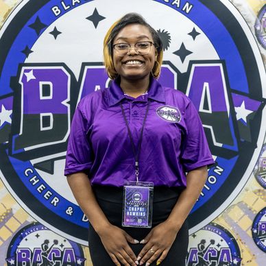 Smiling woman in purple polo with BACA badge standing in front of BACA logo.