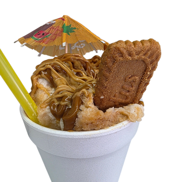 A dessert cup with caramel drizzle, a cookie, and a paper umbrella.