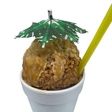 A cup of shaved ice with syrup, a small umbrella, and a yellow straw.