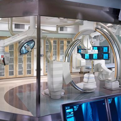High-tech medical imaging and surgical equipment in a modern operating room.