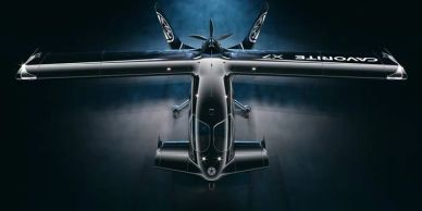 Top view of a sleek black aircraft with wings spread wide.