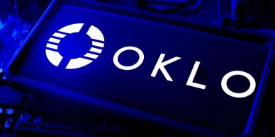 Illuminated OKLO logo in blue lighting.