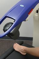 MLS Laser Therapy treating the top of a patient's foot