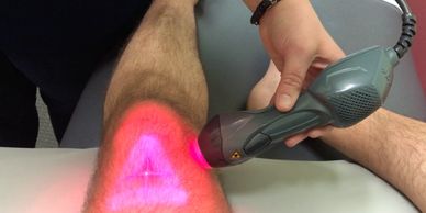 MLS Laser Therapy treating a knee with the Ultra Head and handpiece at the same time