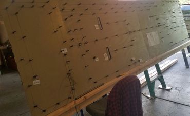 Large tilted board on a stand in a workshop.