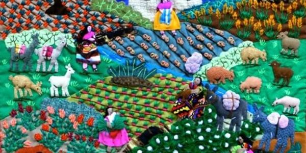 Colorful embroidered textile depicting rural life with animals and people.
