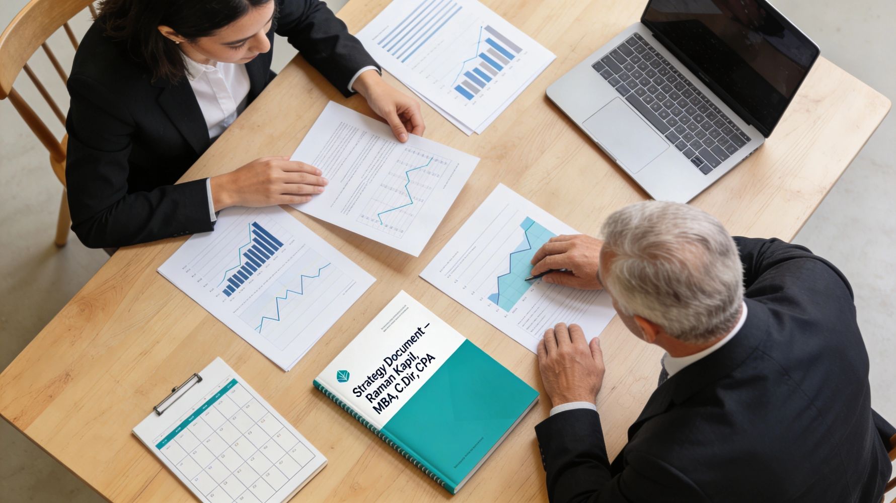 Two professionals analyzing charts and graphs at a wooden table with a laptop and strategy document.