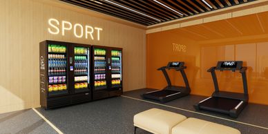 Modern gym corner with treadmills and snack vending machines under a "SPORT" sign.