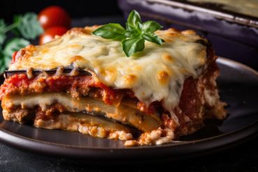 A picture of lasagne garnished with cheese