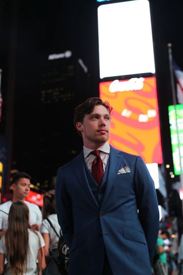 Jared wearing a three-piece made-to-measure suit in Times Square, New York City.