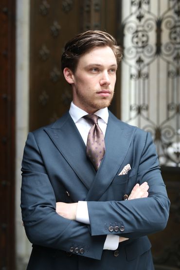 Jared wearing a forest green double breasted suit.