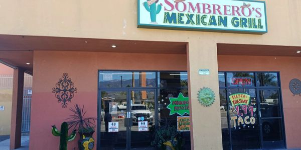 Exterior view of Sombrero's Mexican Grill with colorful signage and promotional posters.