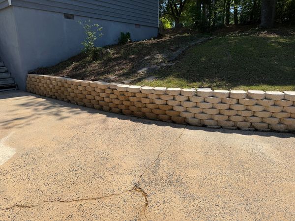 Retaining wall after professional cleaning removed heavy dark organic buildup in Macon, GA.