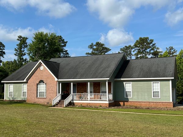 Stained asphalt shingle roof before professional roof cleaning in Gray GA