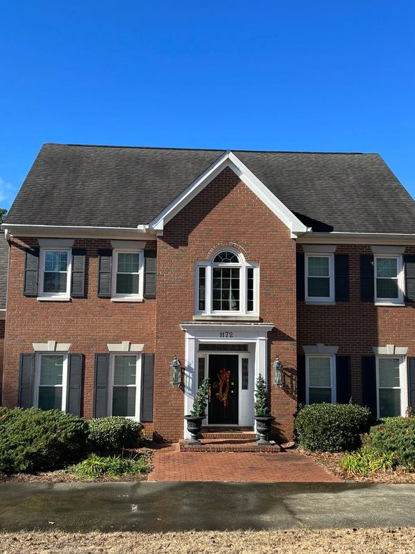 Dark roof staining before professional roof cleaning in Macon GA