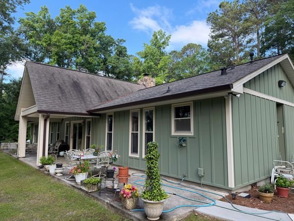 Dark algae staining on asphalt shingle roof before soft wash roof cleaning in Macon GA