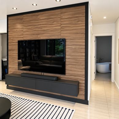 Salon moderne avec mobilier noir et bois.