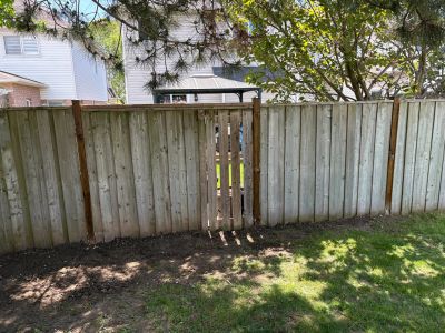 Wooden fence with a small gate.