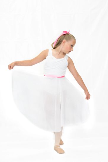 Young ballerina in white tutu posing gracefully.