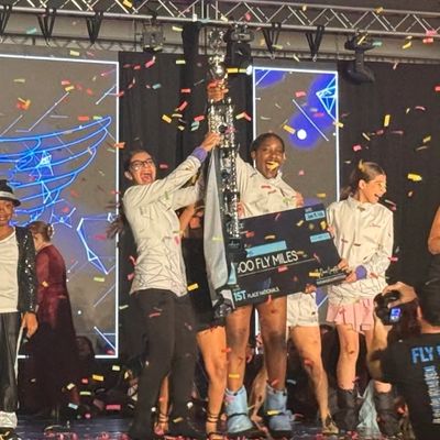 Dance competition winners celebrating on stage with confetti.