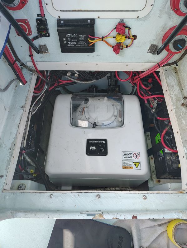 Boat engine compartment with Seabreeze generator and wiring.
