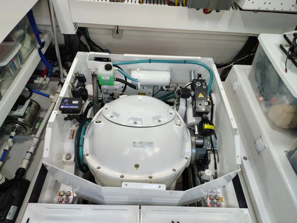 A clean, well-organized engine room with a central white engine and surrounding components.