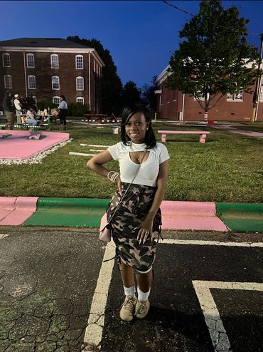 Young woman posing outdoors at night.