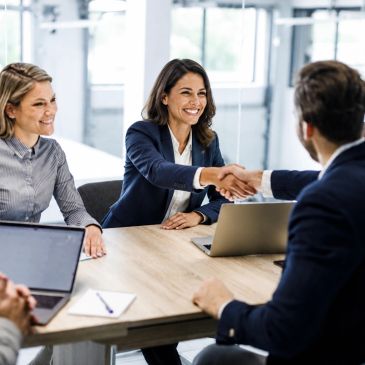 Business professionals shaking hands during a meeting.
