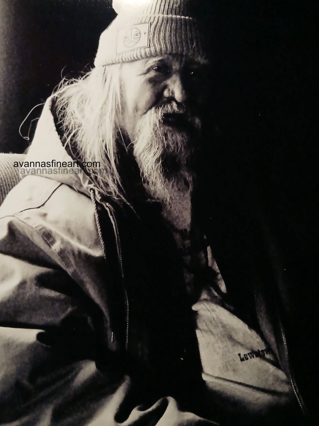Black and white portrait of an elderly man with a beard and beanie.