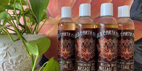 Four bottles of Wild Earth Mama aromatherapy massage oil
