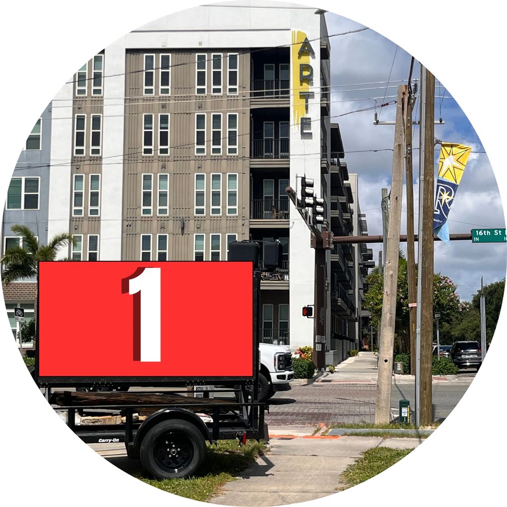 Urban street view with modern apartment building and traffic signal.
