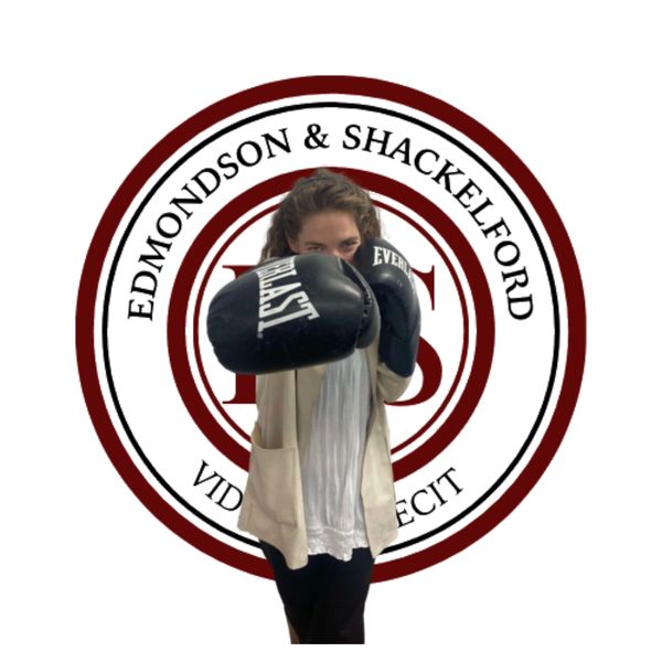 Brittnee Edmondson punching with boxing gloves behind the Edmondson and Shackelford logo