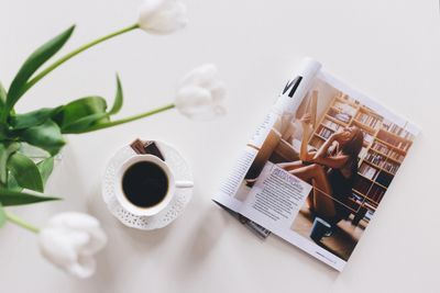 Magazine article and a cup of coffee