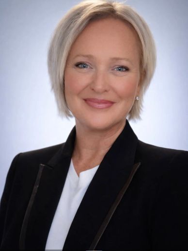 Professional woman smiling in business attire.