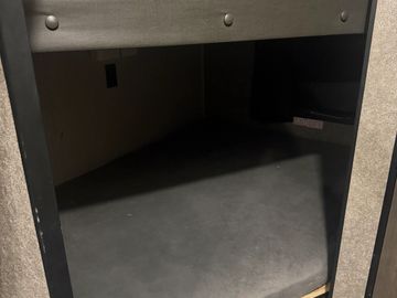 Small dark bunk bed or sleeping area.