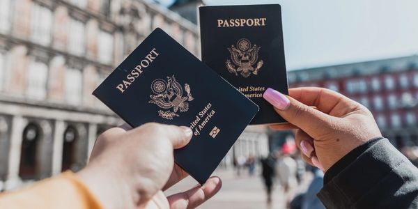 Two people holding up passports