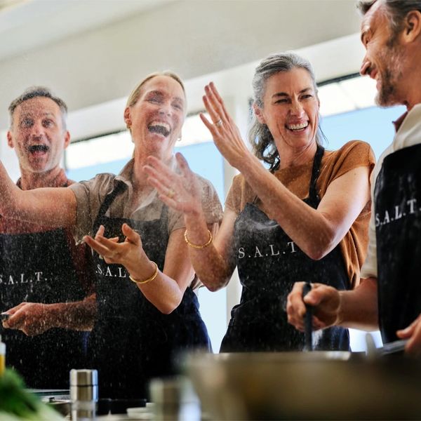 Group enjoys S.A.L.T. cooking class. Fun culinary experience, learn new skills.