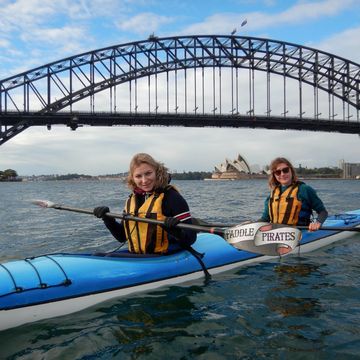 Two kayakers in front of Sydney Harbour Bridge