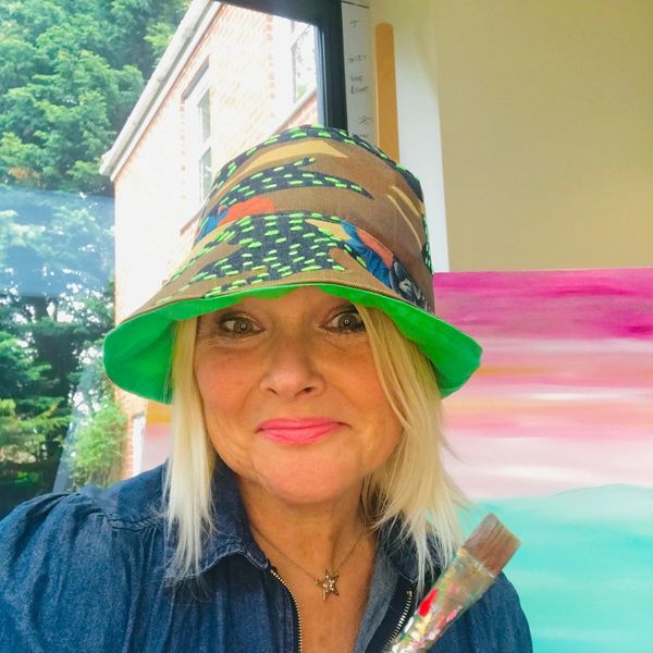 Sara Oxley Artist in studio at the easel with paintbrush 