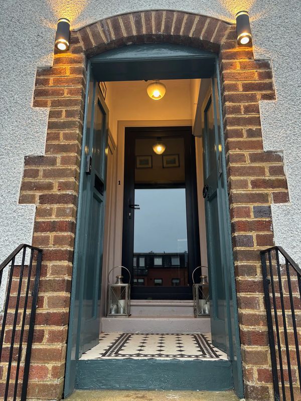 Glass door brick surround tiled entrance modern lighting