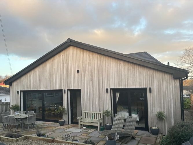 Russwood timber larch bungalow steel windows bifold doors french doors