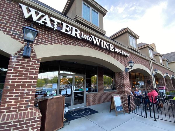 The exterior of Water into Wine including a pet-friendly open-air patio.